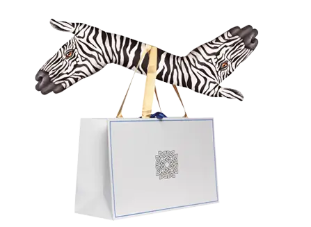 Sac publicitaire en papier luxe blanc suspendu à un cintre avec des motifs zèbre, idéal pour boutiques haut de gamme.